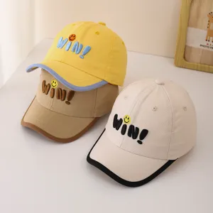 Detail view of cute baby baseball cap with embroidered letters, featuring colorful brim.
