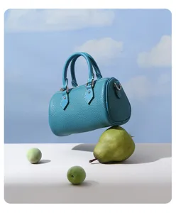 Chic blue genuine leather Boston bag with top handles, ideal for daily commuting and stylish look.