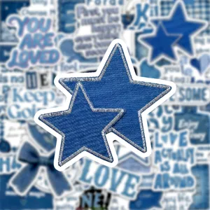 Denim star embroidered patch close up, blue fabric badge detail, DIY clothing accessory.