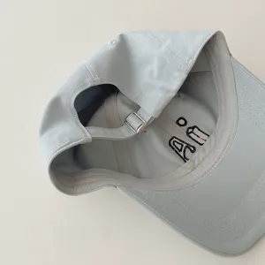 Close-up detail view of the kids baseball cap inner strap and cute embroidery design.