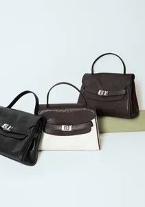 First-layer cowhide commuting women's handbag, stylish color-block flap design with metallic clasp.