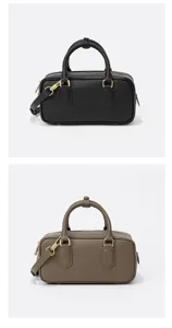 Women leather bowling bag Boston handbag solid color shoulder crossbody bag detail.