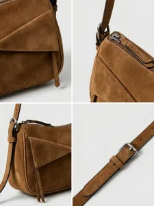 Brown suede shoulder bag detail view showing geometric paneling, zipper and adjustable strap.