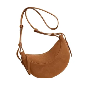 Elegant brown suede crescent shoulder bag for women, minimalist hobo saddle bag for daily use.