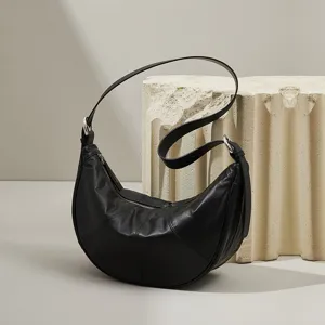 Genuine leather black crescent shoulder bag, fashionable half moon underarm crossbody bag for women.