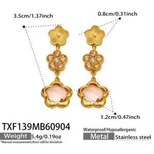 Detailed view of 18k gold plated stainless steel flower crystal drop earrings, 3.5cm length.
