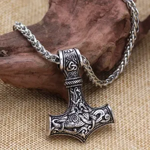Detailed close-up of Viking Mjölnir Thor hammer pendant necklace with intricate Nordic carvings.