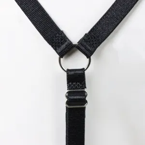 Close-up detail of black elastic strap and silver metal ring hardware for sexy harness.