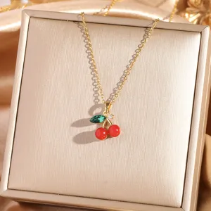 Gold cherry pendant necklace detail, elegant titanium chain with red green stones for women.