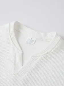 White waffle knit long sleeve t-shirt collar detail showing size S and quality fabric.