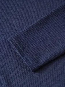 Detailed close-up of mens long sleeve waffle knit t-shirt sleeve cuff in navy blue.