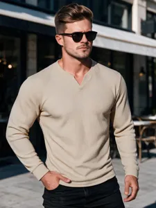 Close-up of men's beige waffle long-sleeve t-shirt with small V-neck, casual outdoor style.