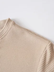 Detailed close-up view of men's casual waffle long sleeve t-shirt collar and shoulder