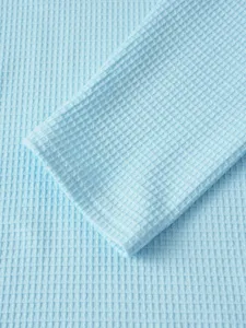 Men's casual waffle knit long sleeve t-shirt detail showing soft light blue textured fabric.