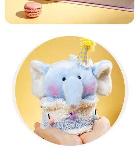 Detailed view of cute blue elephant plush toy with birthday cake body and party hat design.