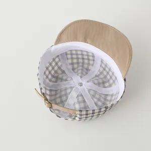 Detailed view of the cute plaid baby baseball cap with soft brim and adjustable strap.