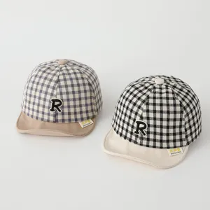 Infant plaid baseball cap detail showing soft brim and cute letter embroidery design.