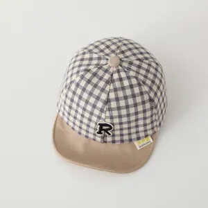 Infant plaid baseball hat detail shot showcasing soft khaki brim and R logo embroidery.