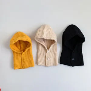 Detailed view of kids knitted balaclava hood with front buttons, soft winter warm baby bib.