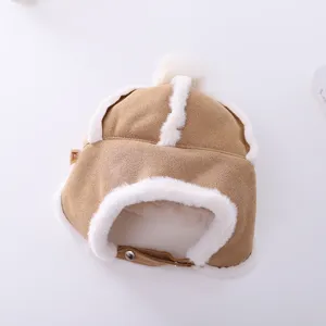 Kids winter warm plush earflap hat, brown faux suede and thick furry lining, detail view.