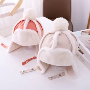 Kids winter warm plush earflap hat with pom-pom and snap button strap, cozy thick design.