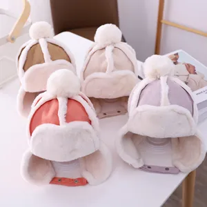 Details of cozy kids winter plush earflap hat with fluffy pompom and warm lining.