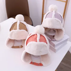 Children winter warm plush ear-flap hat detail view, cute pom-pom fleece trapper cap.