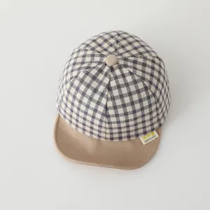 Detailed view of the cute plaid baby baseball cap with soft khaki brim and fabric label.