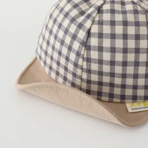 Baby plaid sun hat detail view, soft beige brim and cute checkered pattern for infants.