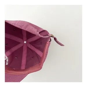 Kids washed vintage baseball cap detail view, adjustable strap, breathable cotton fabric.