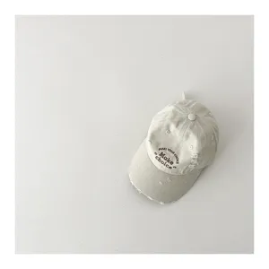 Kids vintage distressed baseball cap with embroidered letters, stylish sun protection design.
