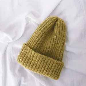 Close up view of a cozy yellow knitted beanie, soft ribbed texture for kids warm winter wear.