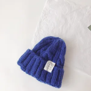 Kids blue cable knit beanie hat, cozy winter warm pull-on cap with stylish fabric label.