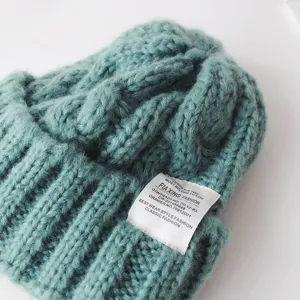 Kids chunky knit beanie winter warm hat close up detail showing texture and sewn label design