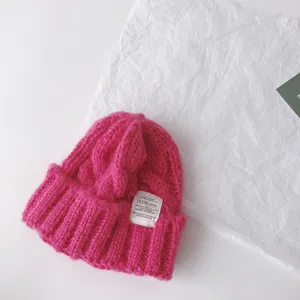 Pink cable-knit children winter beanie hat with woven label stylish warm pullover cap