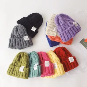 Colorful knitted beanie hats for kids, warm winter caps with cute cloth labels, cozy.