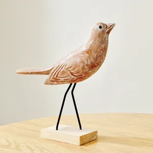 Rustic wooden bird figurine with metal legs and base, ideal for home decor and display.