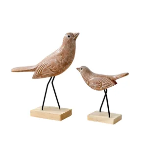 Rustic wooden bird figurine set with metal legs and wooden base for home decoration.