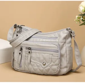 Vrouwen multi-pocket schoudertas grijze PU leer casual crossbody tas met gewatteerd design.