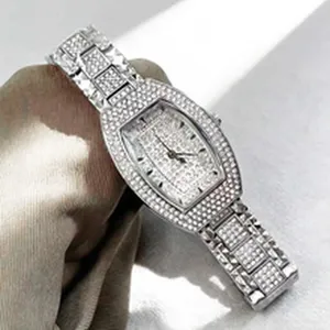 Close-up of luxury crystal encrusted tonneau quartz watch with sparkling dial.