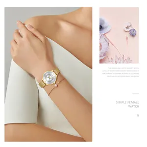 Elegant women's quartz watch featuring a gold mesh strap, sparkling dial, and delicate bracelet.