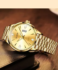 Close-up view of a luxury gold quartz watch showcasing metallic strap and date window details.