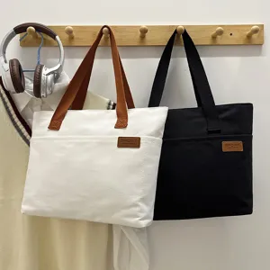 Minimalist canvas tote bag for women, large capacity daily shoulder bag with front pocket.