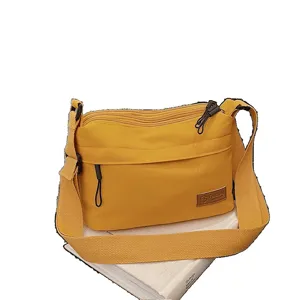 Yellow multi-compartment canvas crossbody bag, minimalist Japanese style shoulder bag.