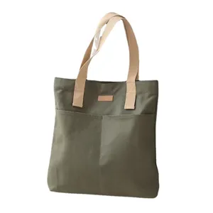 Large capacity canvas tote bag for women, casual commuter shoulder bag with front pockets.