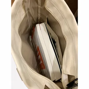 Spacious canvas tote bag for women, casual daily shoulder bag with large capacity for commuting.