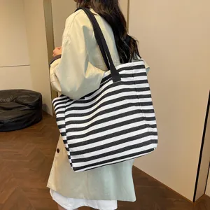 Fashionable women large capacity canvas tote bag with black white stripes for daily commuting.