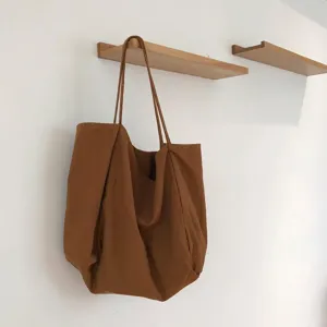 Minimalist brown canvas shoulder bag, large capacity everyday tote for women versatile.