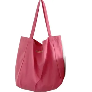 Pink canvas tote bag for women, casual shoulder bag with letter print for daily shopping use.