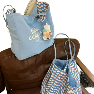 Large capacity reversible canvas tote bag stylish casual shoulder bag for daily commute.